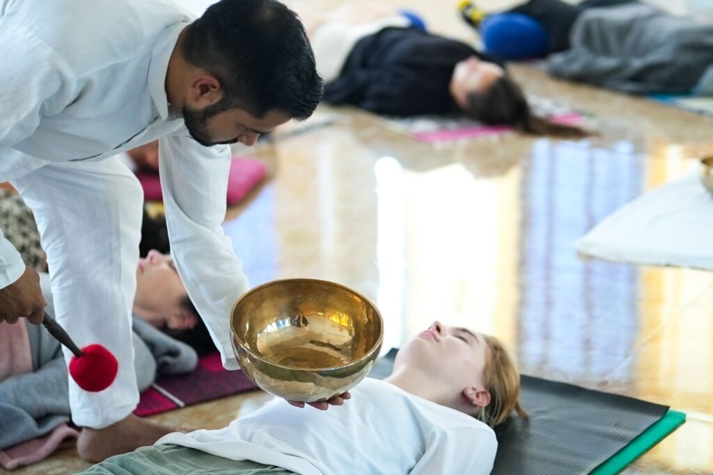 A relaxing sound healing session with a practitioner using singing bowls, promoting mindfulness and relaxation.